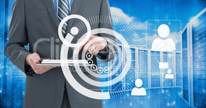 Business man holding a tablet and graphics in server room