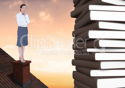 Woman on roof looking at 3D books