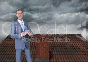 Businessman on roof with clouds