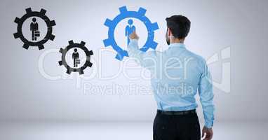 Businessman interacting and choosing a person from group of people icons with cog gear settings symb