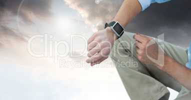 Man under sky clouds with watch