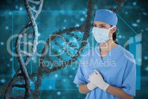 Doctor woman standing with 3D DNA strands against blue background