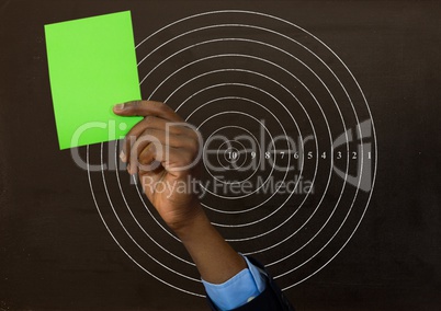 Hand holding green card in front of circle radius numbers