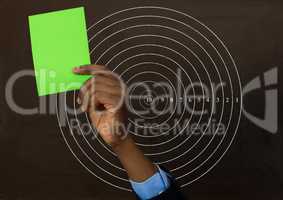 Hand holding green card in front of circle radius numbers