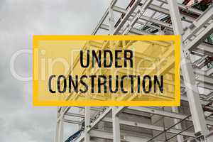 Under construction text against construction photo