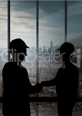 Business handshake silhouette against building