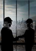 Business handshake silhouette against building