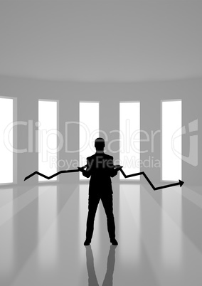 Business man holding an arrow silhouette against building