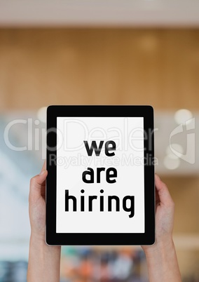 Business woman holding a tablet with we are hiring text