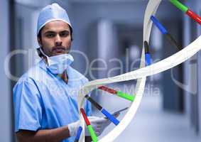 Doctor standing with 3D DNA strand