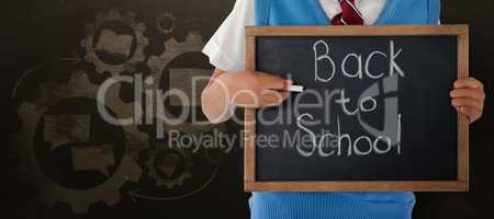 Composite image of midsection of schoolboy holding slate with back to school text