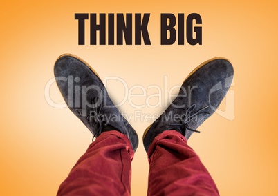Think big text and Grey shoes on feet with orange background