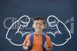 Happy student boy with fists graphic standing against blue blackboard