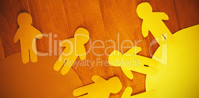 Blue and yellow paper cut out figures on table