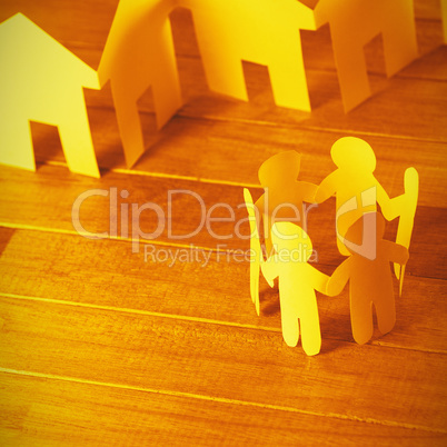 Paper figures and houses on wooden table