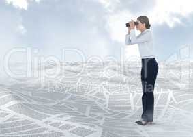 Businesswoman holding binoculars in sea of documents under sky clouds