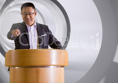 Businessman on podium speaking at conference with tunnel