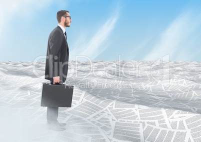 Businessman holding briefcase in sea of documents under sky clouds