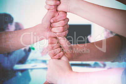 Composite image of cropped image of people stacking fists