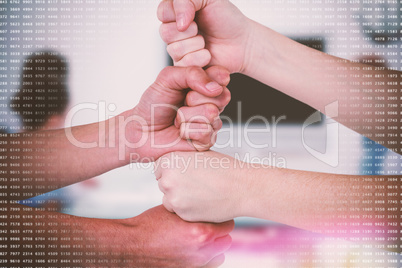 Composite image of cropped image of people with stacked fists