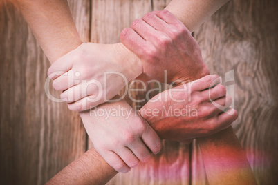 Composite image of cropped image of people forming hand chain