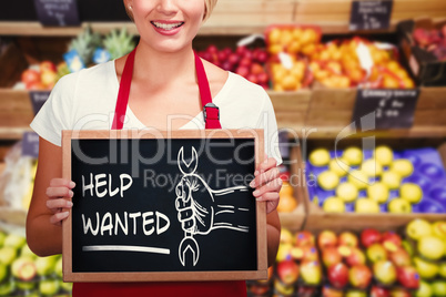 Composite image of portrait of smiling young woman holding chalkboard
