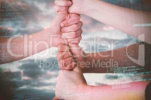 Composite image of cropped image of people stacking fists