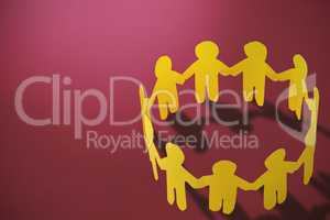 Composite image of  group of yellow little person holding hands