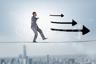 Composite image of businessman performing a balancing act