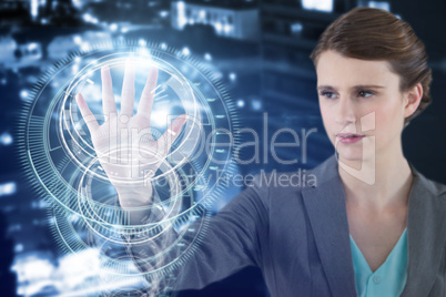 Composite image of businesswoman touching digital screen