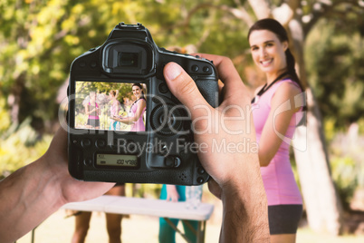 Composite image of cropped image of hands holding camera