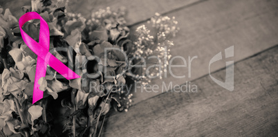 High angle view of pink Breast Cancer Awareness ribbon on flowers