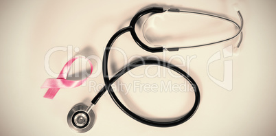 Directly above view of stethoscope by Breast Cancer Awareness ribbon Directly above view of stethoscope by Breast Cancer Awareness ribbon