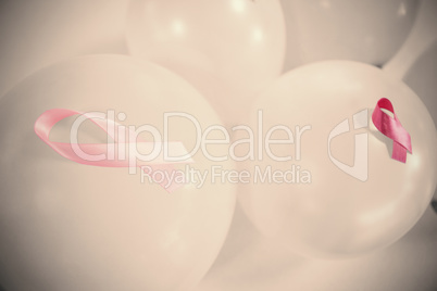 High angle view of pink Breast Cancer Awareness ribbons on balloons