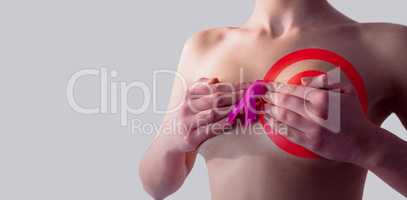 Composite image of nude woman with breast cancer ribbon