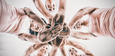 Women wearing pink for breast cancer and putting hands together