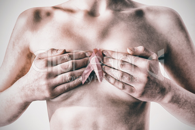 Nude woman with breast cancer ribbon