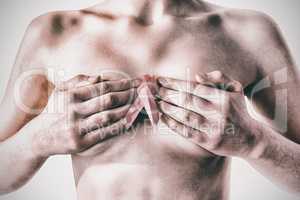Nude woman with breast cancer ribbon