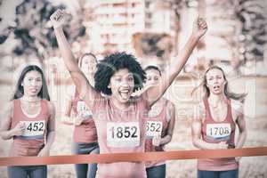 Cheering young woman winning breast cancer marathon