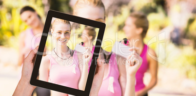 Composite image of close-up of hands holding digital tablet