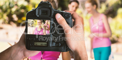 Composite image of cropped image of hands holding camera