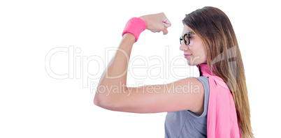 Woman in superhero costume while flexing muscles