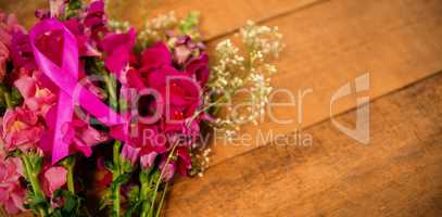 High angle view of pink Breast Cancer Awareness ribbon on flowers