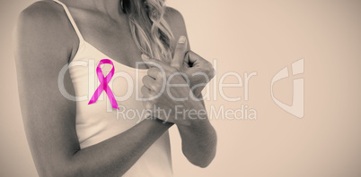 Mid section of young woman with pink ribbon