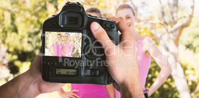 Composite image of cropped image of hands holding camera