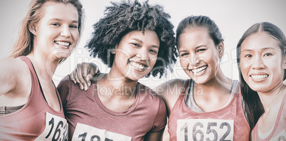 Four smiling runners supporting breast cancer marathon