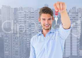 Man  Holding key in front of high rise apartments