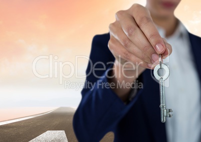 Woman  Holding key in front of road