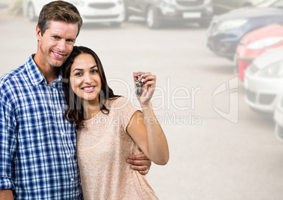 Couple  Holding key in front of cars