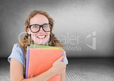 Nerd woman with books in grey room